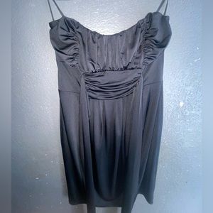 Meduim length black silky dress.